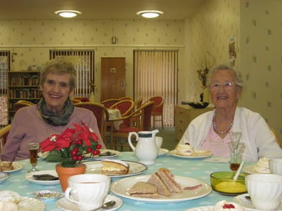 Two women clients of Age UK Todmorden enjoying a coffee morning